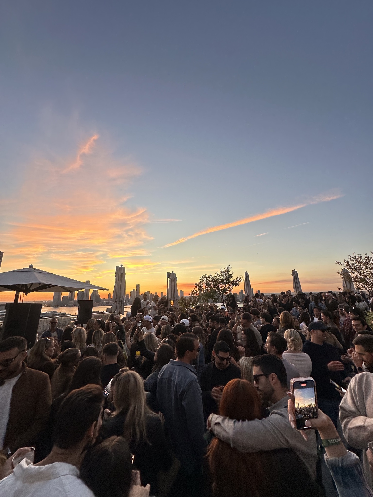 treehouse. NYC — packed rooftop crowd at golden hour