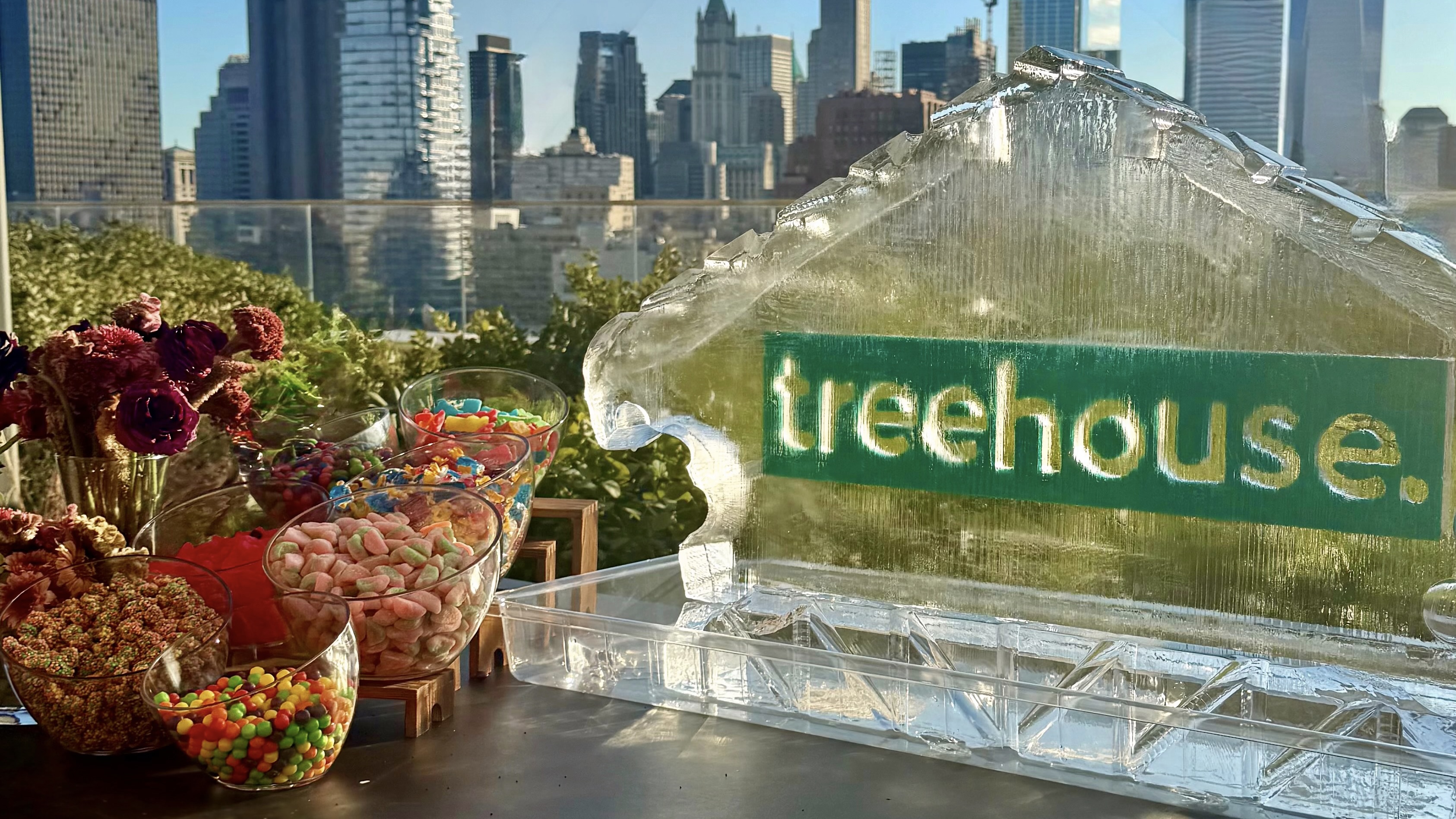 Treehouse Events branded ice sculpture with NYC skyline and candy bar